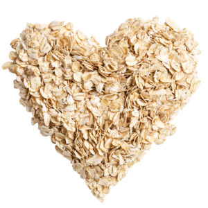 heap of oat flakes in a shape of heart shot from above
