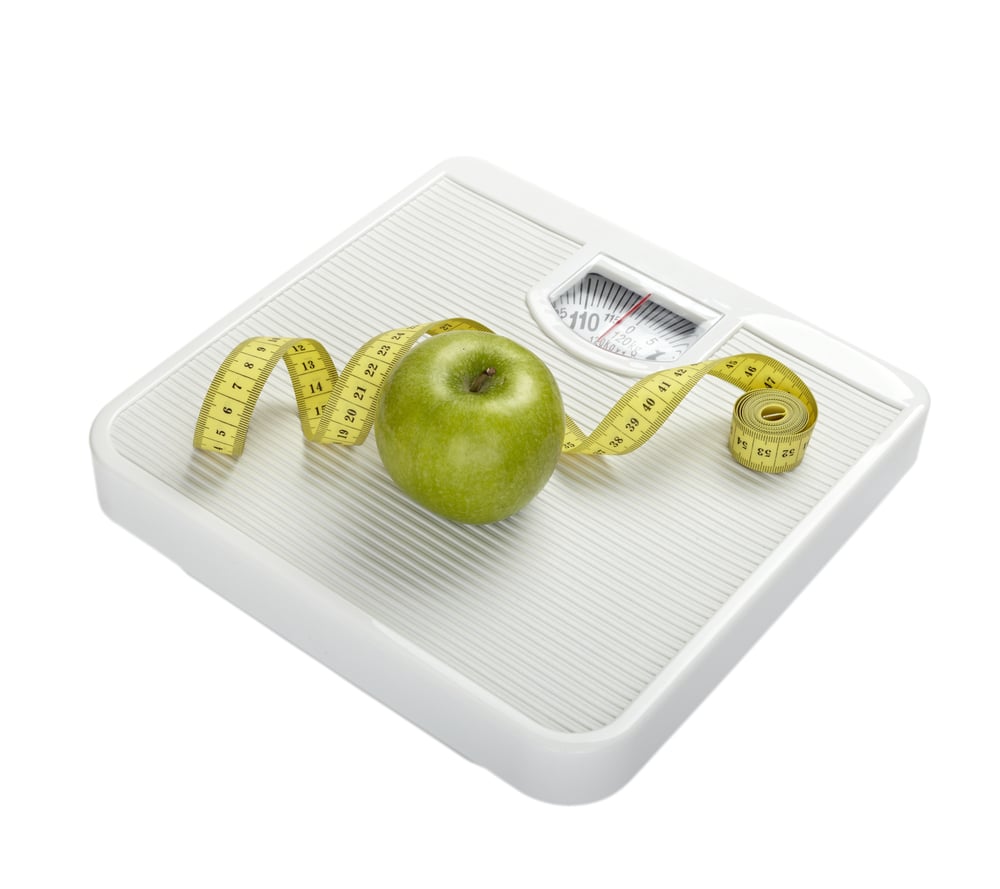 close up of scale, tape and apple on white background with clipping path