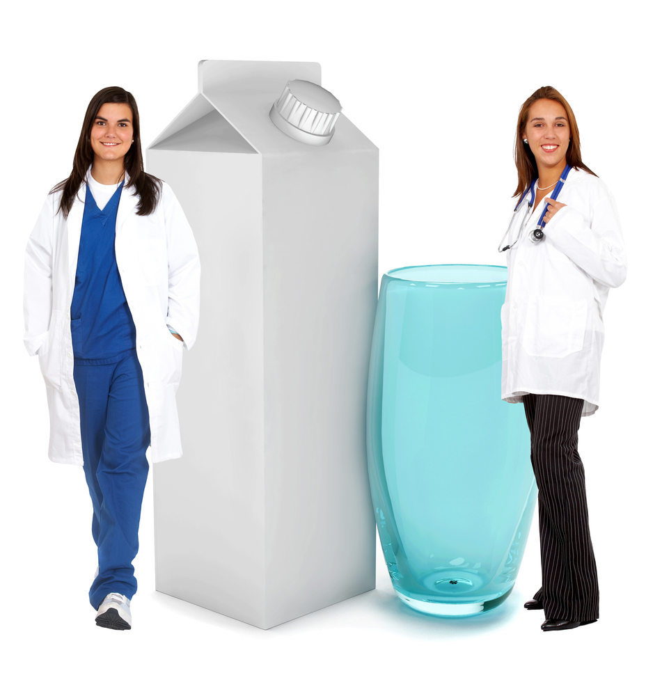 Doctors with a carton of milk isolated on white