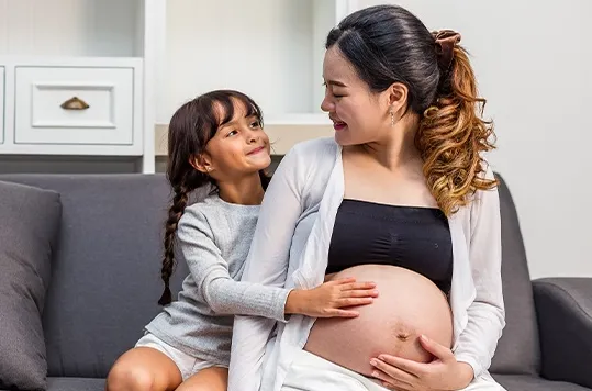 Girl loving her pregnant mother